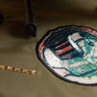 CANVAS GREEN Sac The Rucksack medium en nylon technique avec appliqué à motif Pallas Heads